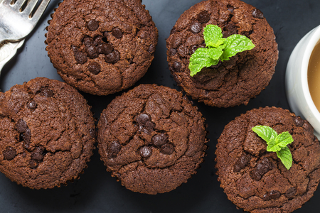 chocolate muffin with mint on a wooden tableの写真素材