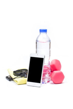 sport, healthy lifestyle and objects concept - close up of dumbbells, fitness tracker, earphones and water bottle over white backgroundの写真素材