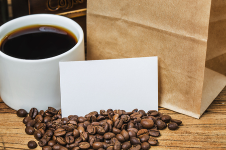 Blank business cards and cup of coffee on wooden table. Corporate stationary branding mock up.の写真素材