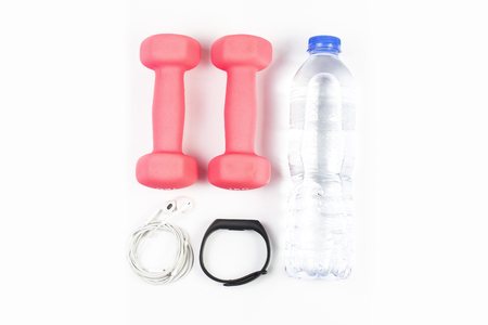 sport, healthy lifestyle and objects concept - close up of dumbbells, fitness tracker, earphones and water bottle over white backgroundの写真素材