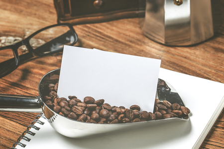 Blank business cards and scoop of coffee bean on wooden table. Corporate stationary branding mock up.の写真素材