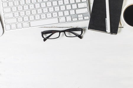 Blank paperwork template for designers. Responsive design mockup on vintage wooden background. Paper, letterhead, coffee cup, smartphone, pencil and headphones on wooden table background. Top view.のeditorial素材