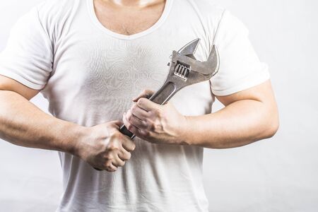 Man holding an adjustable wrenchの写真素材