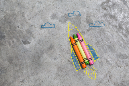 Back to school concept - rocket made from pencils, crayons and chalksの写真素材