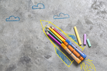 Back to school concept. rocket made from pencils, crayons and chalksの写真素材