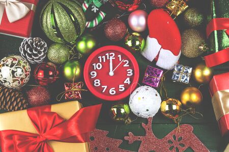 Christmas background with decorations and gift boxes on wooden board