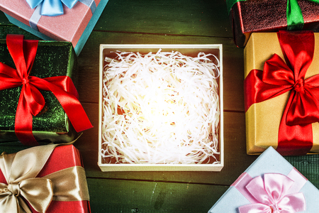 Christmas background with decorations and gift boxes on wooden boardの写真素材