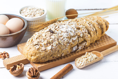 Top view of sliced wholegrain bread on a wooden cutting board.