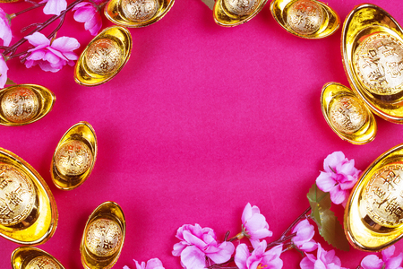 Chinese new year festival decorations, ang pow or red packet and gold ingots. Chinese characters means luck,wealth and prosperity.の写真素材