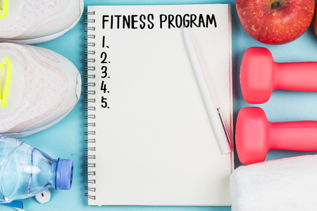 Sports shoes, dumbbell fitness in the blue background. Different sports toolsの写真素材