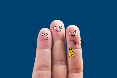 Four fingers with robbery expression on dark blue backgroundの写真素材