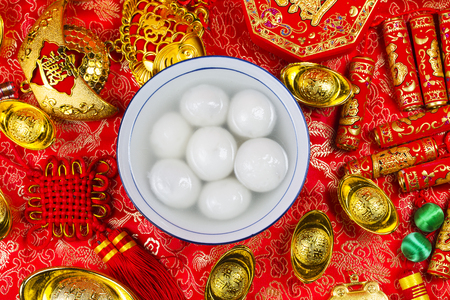 Chinese Lantern Festival food,ang pow or red packet and gold ingots. Chinese characters means luck,wealth and prosperity.の写真素材