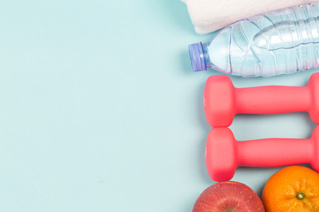 Sports shoes, dumbbell fitness in the blue background. Different sports toolsの写真素材