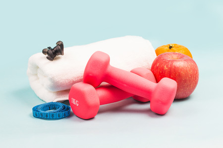 Sports shoes, dumbbell fitness in the blue background. Different sports toolsの写真素材