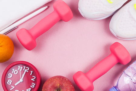 Sports shoes, dumbbell  , in the pink background. Different sports toolsの写真素材
