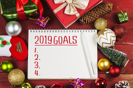 2019 goals with  christmas presents and decorations on wooden table.