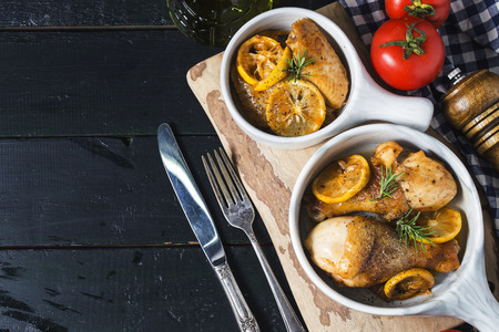 Roasted chicken legs with lemon and herbsの写真素材