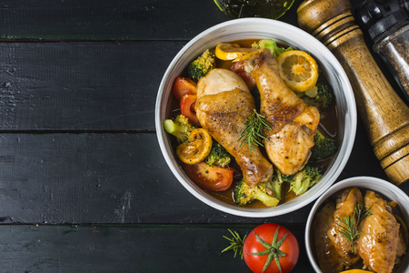 roasted chicken legs with vegetables and herbsの写真素材