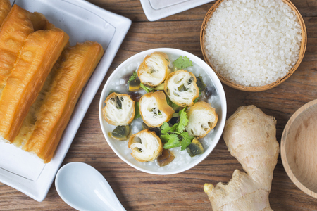 Chinese preserved egg and lean meat porridge with youtiao for breakfastの写真素材
