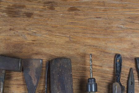 Collection of vintage wood and hand tools on a workbench with copy space