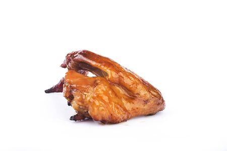 Baked honey chicken wing on a white backgroundの写真素材