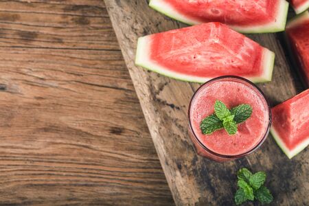 Fresh watermelon juice and fruits on wooden board backgroundの写真素材