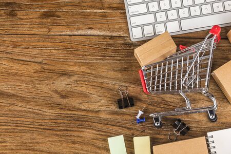 shopping online at home concept.Cartons in a shopping cart on a laptop keyboard.online shopping is a form of electronic commerce that allows consumers to directly buy goods from a seller over internetの写真素材