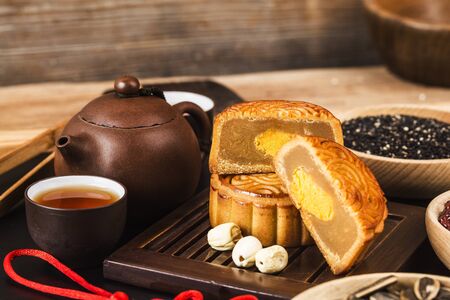 Traditional mooncakes on table setting with teacup.