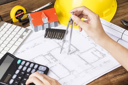 Architect using calculator at his work. The concept of architectureの写真素材