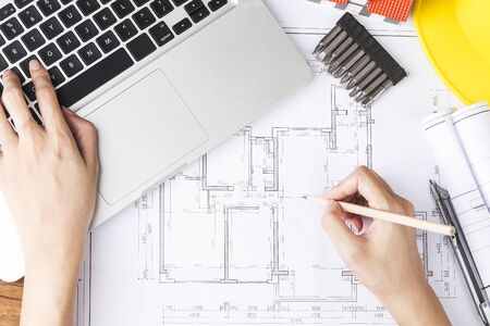 Hand drawing plan on blueprint with architect accessories. The concept of architecture