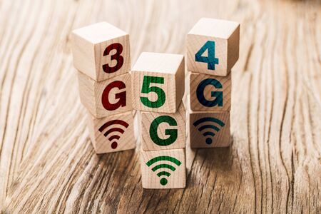 5G (5th Generation) network connecting technology future global. Hand flip wood cube change number 4G to 5Gの写真素材