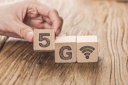 5G (5th Generation) network connecting technology future global. Hand flip wood cube change number 4G to 5Gの写真素材