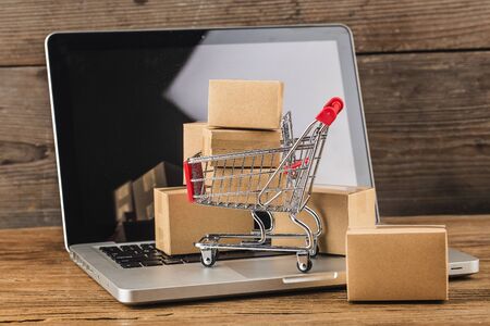 shopping online at home concept.Cartons in a shopping cart on a laptop keyboardの写真素材