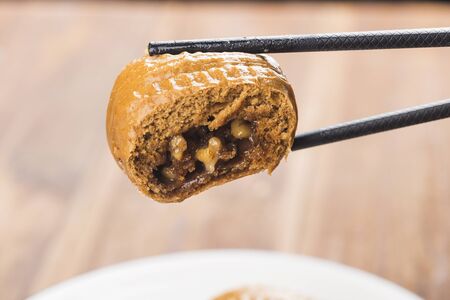Traditional southern China brown bun filled with walnut creamの写真素材