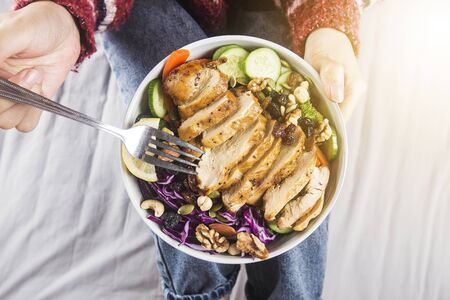 Clean and balanced healthy food conceptï¼Housewife relaxed enjoying chicken breast salad at homeの写真素材