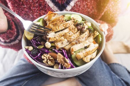 Clean and balanced healthy food conceptï¼Housewife relaxed enjoying chicken breast salad at homeの写真素材