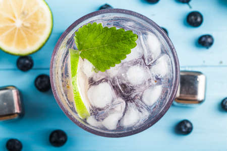 Summer refreshment drinks, Blueberry Lemonade or mojito cocktail with lemon, fresh blueberries and mint, の写真素材