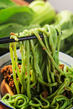 Traditional Chinese cuisine: spinach noodlesの写真素材
