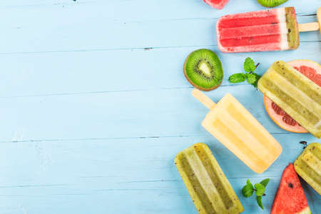 Healthy Whole Fruit ice cream stick with Berries Kiwi watermelon cantaloupe on wooden vintage tableの写真素材