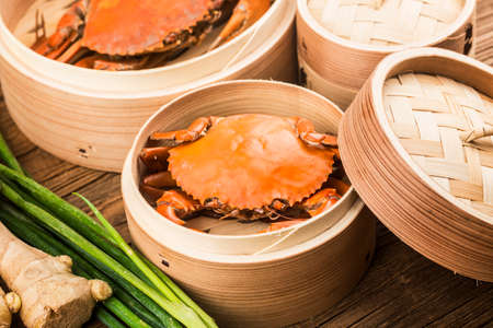 Cooked crab on steamer and Wooden planks backgroundの写真素材