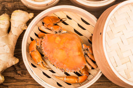 Cooked crab on steamer and Wooden planks backgroundの写真素材