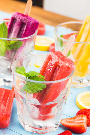 Healthy Whole Fruit ice pop with Berries Strawberry orange Dragon fruit on wooden vintage tableの写真素材