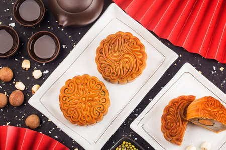 Mid-Autumn Festival concept, Traditional mooncakes on table with teacup.