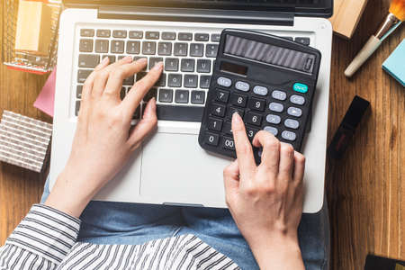 A woman is using a computer to shop online