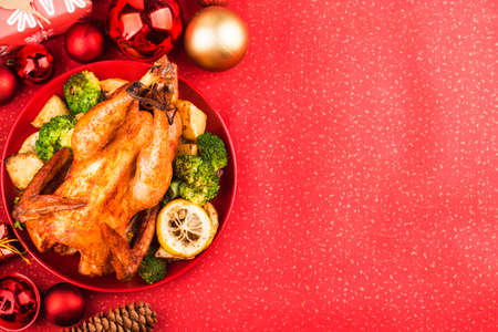 Roasted whole chicken with Christmas decoration.の写真素材