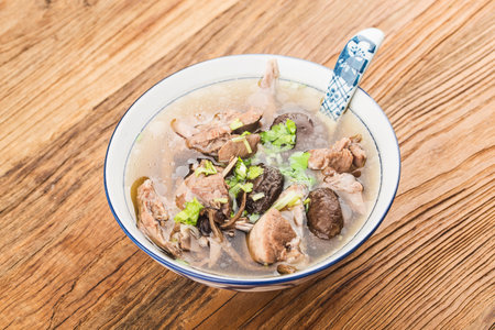 A bowl of mushroom lao duck soup on a cutting boardの写真素材