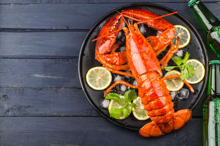 Seafood feast, Lemon and fresh Boston lobster on the iceの写真素材