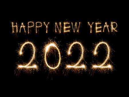 Happy New Year 2022. Sparkling burning text Happy New Year 2022 isolated on black background. Beautiful Glowing golden overlay object for design holiday greeting cardの写真素材