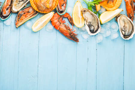 Seafood dinner, seafood dinner with fresh lobster, crab, mussel and oyster as backgroundの写真素材