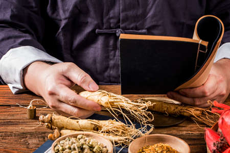 A Chinese medicine practitioner is selecting ginseng, traditional Chinese medicine